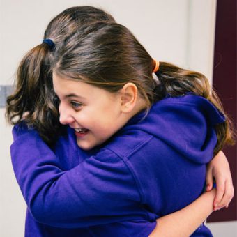 DancePro Academy pupils hugging